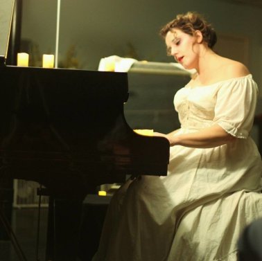 Kristen Zaza playing piano for her podcast, On A Dark Cold Night